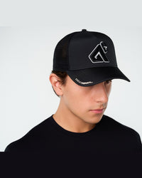 Black Primis Trucker Hat, three-quarter on-model